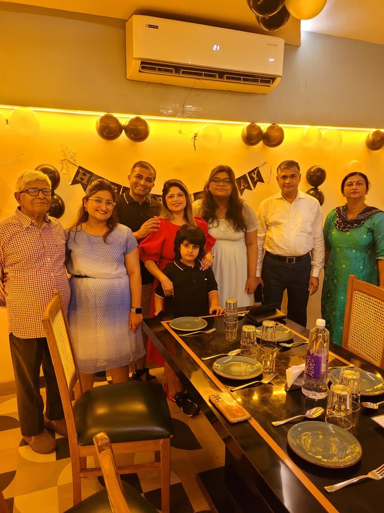 Vyom Pratap Pathak surrounded by his loving family and grandparents at a celebratory dinner table