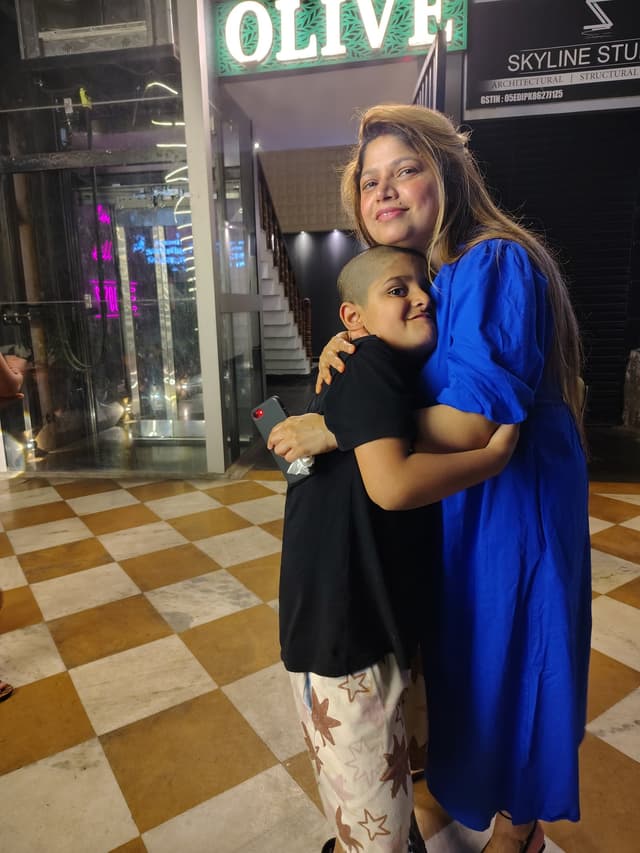 Vyom lovingly hugging his Mom