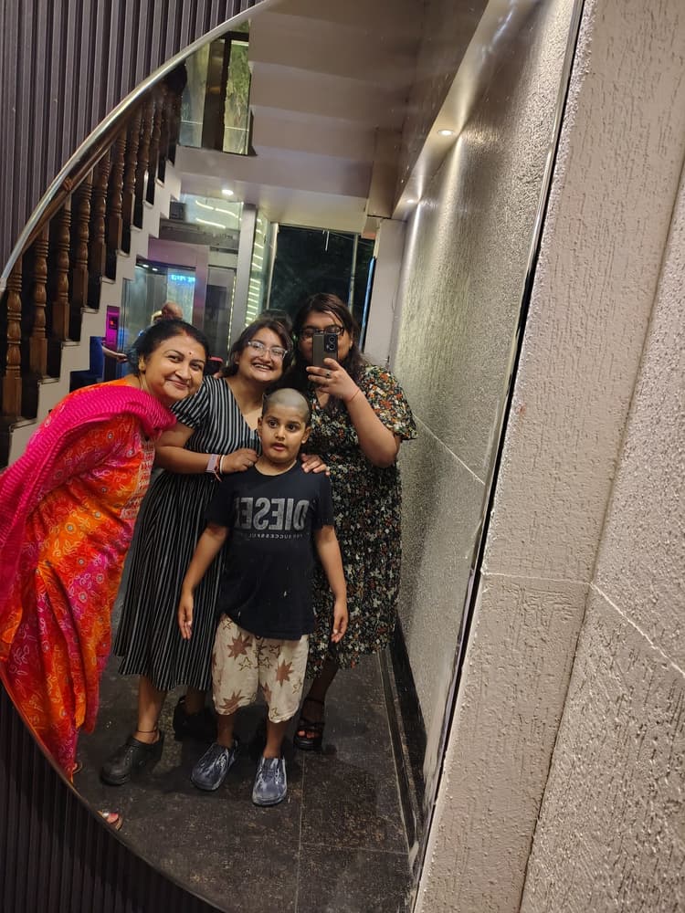 Vyom smiling happily alongside family members in an expressive group photo