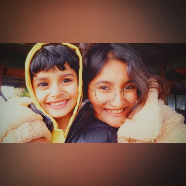 Vyom with bright musical smile in yellow hoodie