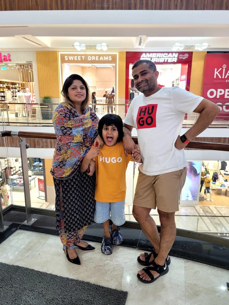 Vyom holding hands with Mom and Dad in matching Hugo t-shirts, roaring with exuberant joy